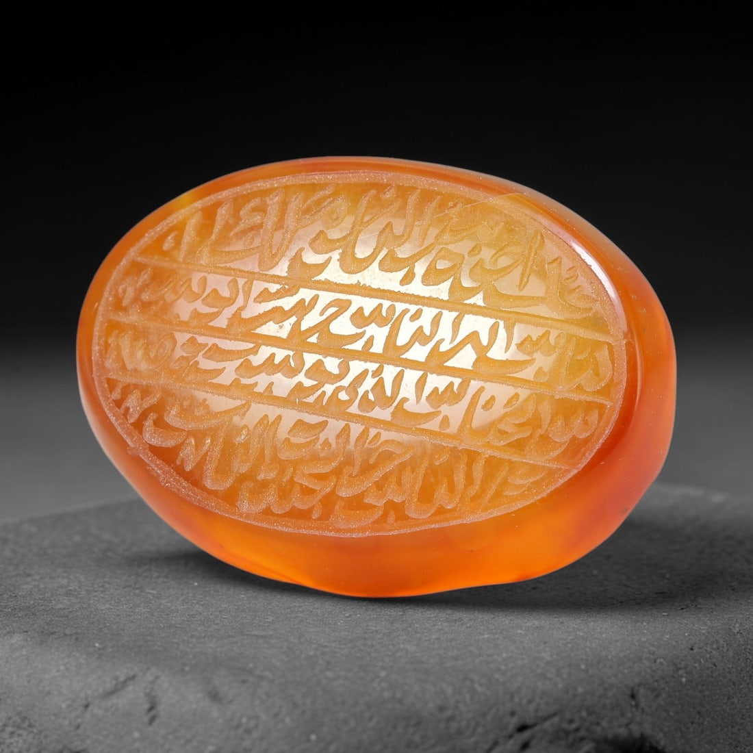 Ancient Medieval Mughal Islamic Carnelian Agate Calligraphic Script Talisman 1526-1857 CE, 12ET: Polished rich-toned carnelian agate cabochon, finely engraved with divided panels of Islamic calligraphic intaglio inscriptions. Deep crisp engraving features segmenting incised lines organizing the s