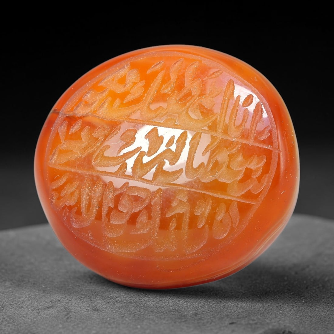 Ancient Medieval Mughal Islamic Carnelian Agate Calligraphic Script Talisman 1526-1857 CE, 13ET: Polished rich-toned carnelian agate cabochon, finely engraved with divided panels of Islamic calligraphic intaglio inscriptions. Deep crisp engraving features segmenting incised lines organizing the s