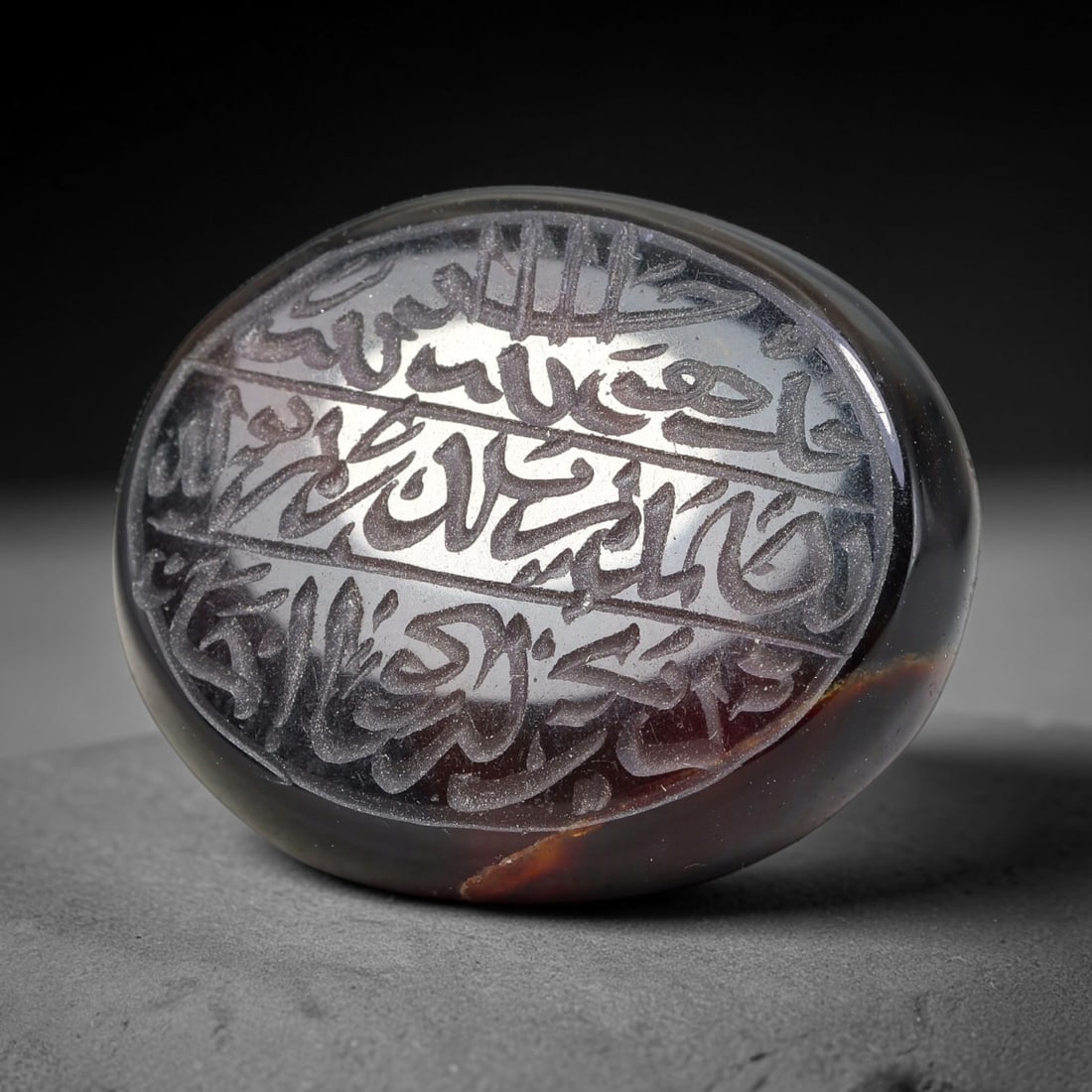 Ancient Medieval Mughal Islamic Carnelian Agate Calligraphic Script Talisman 1526-1857 CE, 20ET: Polished rich-toned carnelian agate cabochon, finely engraved with divided panels of Islamic calligraphic intaglio inscriptions. Deep crisp engraving features segmenting incised lines organizing the s