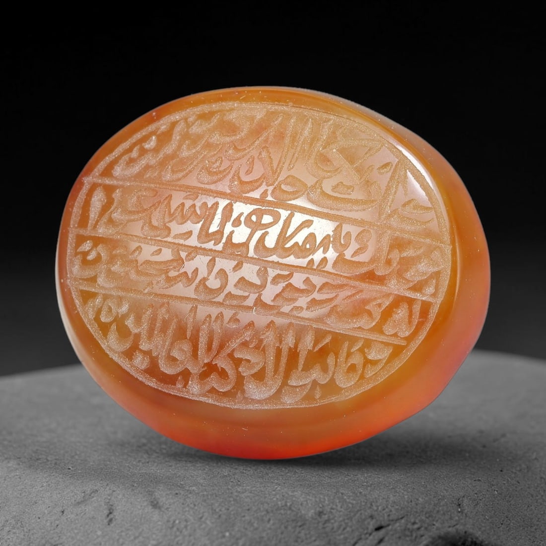 Ancient Medieval Mughal Islamic Carnelian Agate Calligraphic Script Talisman 1526-1857 CE, 94ES: Polished rich-toned carnelian agate cabochon, finely engraved with divided panels of Islamic calligraphic intaglio inscriptions. Deep crisp engraving features segmenting incised lines organizing the s