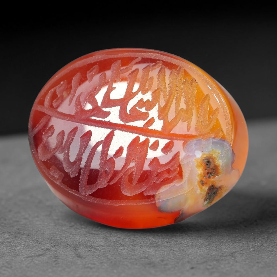 Ancient Medieval Mughal Islamic Carnelian Agate Calligraphic Script Talisman 1526-1857 CE, 23ET: Polished rich-toned carnelian agate cabochon, finely engraved with divided panels of Islamic calligraphic intaglio inscriptions. Deep crisp engraving features segmenting incised lines organizing the s