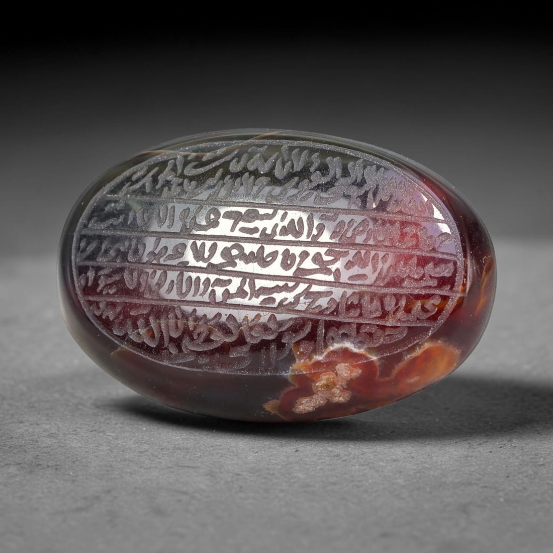 Ancient Medieval Mughal Islamic Carnelian Agate Calligraphic Script Talisman 1526-1857 CE, 2ET: Polished rich-toned carnelian agate cabochon, finely engraved with divided panels of Islamic calligraphic intaglio inscriptions. Deep crisp engraving features segmenting incised lines organizing the s