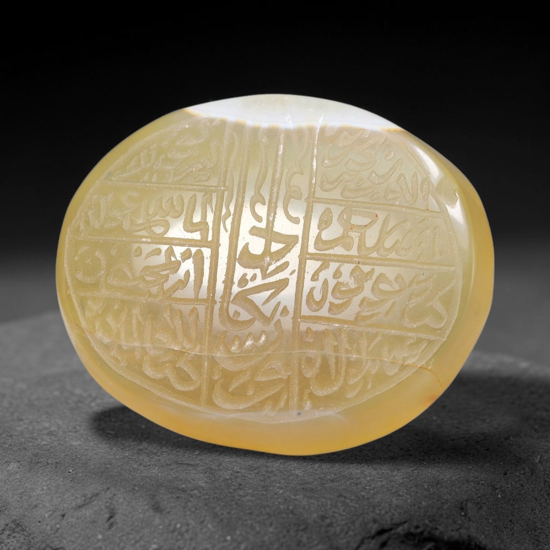 Ancient Medieval Mughal Islamic Carnelian Agate Calligraphic Script Talisman 1526-1857 CE, 1ET: Polished rich-toned carnelian agate cabochon, finely engraved with divided panels of Islamic calligraphic intaglio inscriptions. Deep crisp engraving features segmenting incised lines organizing the s