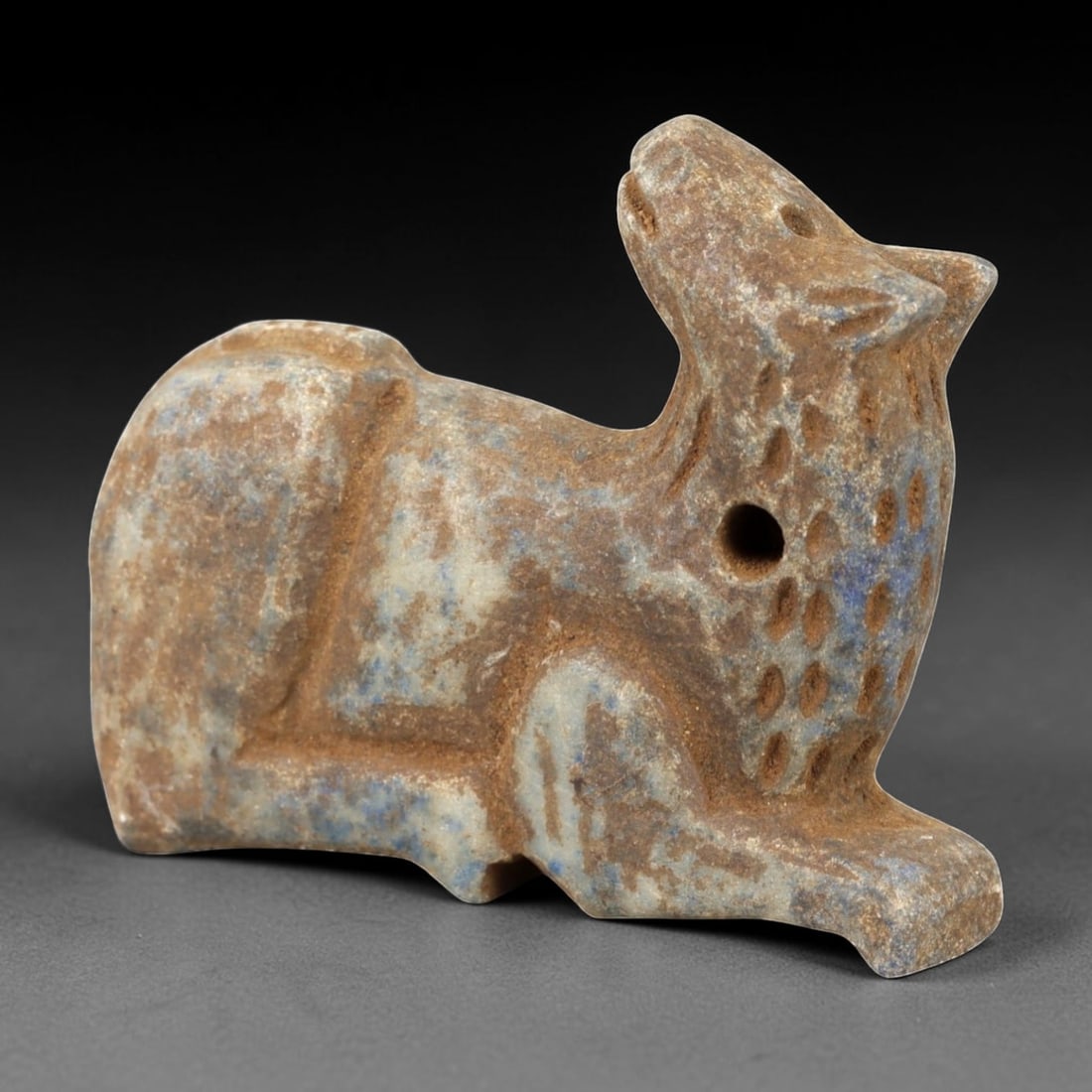 Ancient Lapis Lazuli Camel Amulet - Near Eastern Animal Talisman, 61AM: This amulet is carved from rich blue lapis lazuli with natural earthy inclusions, depicting a stylized camel in a recumbent, crouched posture. The piece features incised linear and stippled detailing 