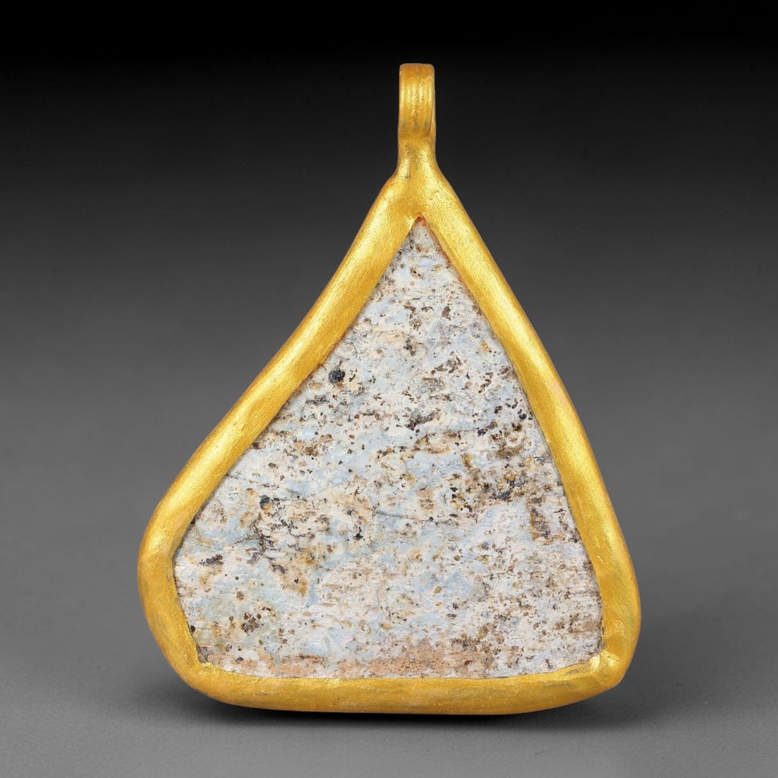 Ancient Roman Glass Slag in Modern Gilt-Edge Pendant, 54FY: This contemporary pendant is crafted from ancient Roman glass slag, featuring a fragmented, iridescent glass surface with weathered patina. The irregular form is bordered by a subtle gilt frame, added