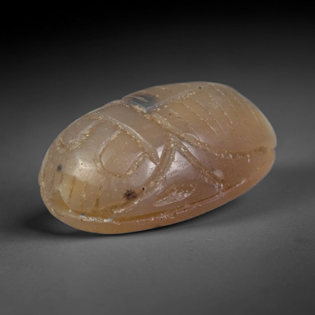 Ancient Pharaonic Egyptian Agate Scarab Amulet Bead (3100 BCE-30 CE), 43EC: This antique scarab amulet bead is carved from natural agate, originating from Pharaonic Egyptian culture. Scarabs were sacred protective talismans closely linked to rebirth and eternal life within an