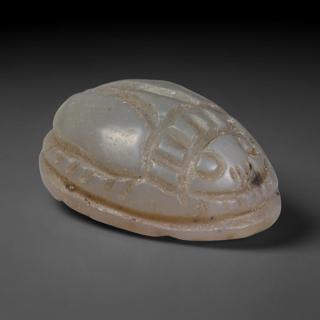 Ancient Pharaonic Egyptian Agate Scarab Amulet Bead (3100 BCE-30 CE), 36EC: This antique scarab amulet bead is carved from natural agate, originating from Pharaonic Egyptian culture. Scarabs were sacred protective talismans closely linked to rebirth and eternal life within an