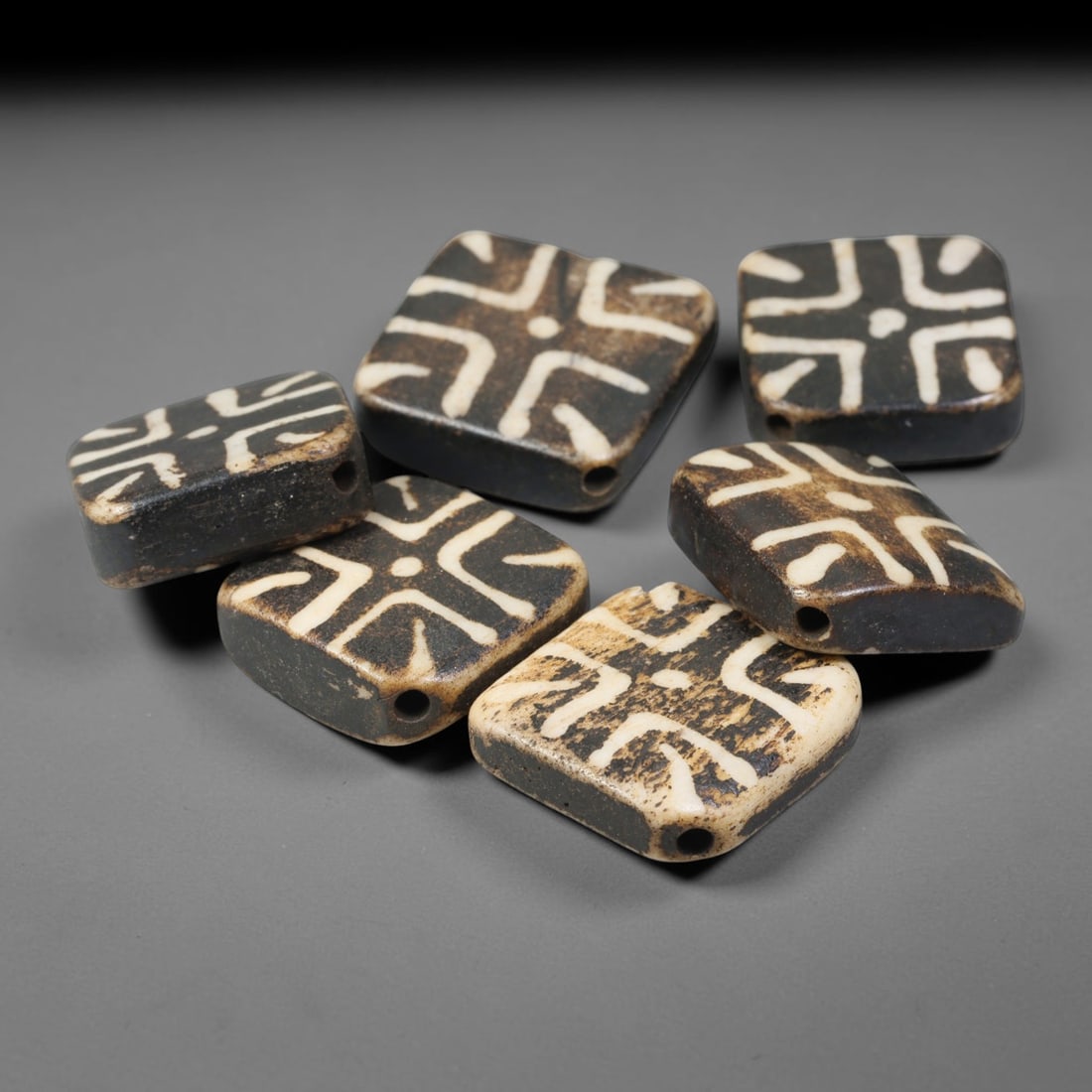 Antique Indo-Himalayan Pumtek Wood Etched Square Beads, 96ET: A fine set of six antique Indo-Himalayan pumtek wood square beads, adorned with classic etched symbolic surface patterns. The beads exhibit deep, accumulated age-developed patina, soft surface wear, a