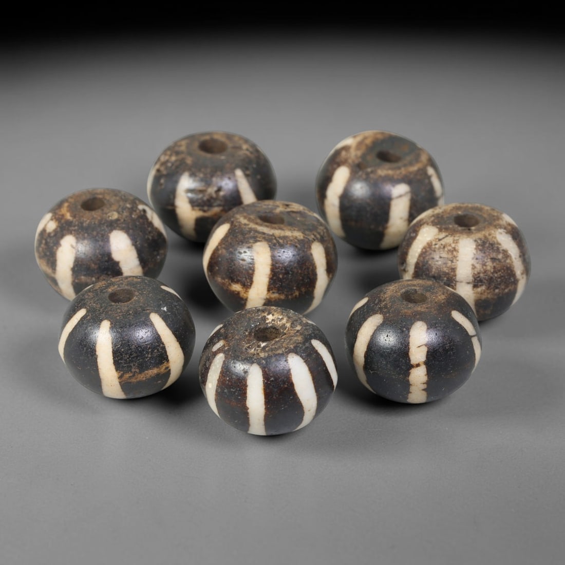 Antique Indo-Himalayan Pumtek Wood Round Striped Etched Beads, 98ET: Fine assembled set of antique Indo-Himalayan pumtek wood round beads decorated with classic vertical etched stripe motifs. The grouping shows natural material variation, deep accumulated patina, and g