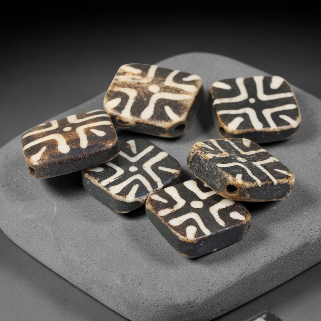 Antique Indo-Himalayan Pumtek Wood Etched Square Beads, 6EV: A fine set of six antique Indo-Himalayan pumtek wood square beads, adorned with classic etched symbolic surface patterns. The beads exhibit deep, accumulated age-developed patina, soft surface wear, a