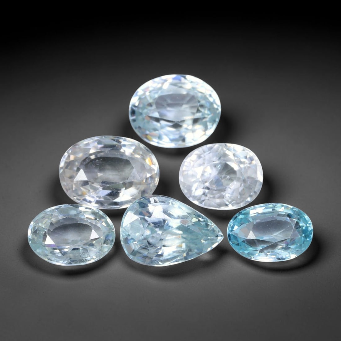 8.32ct Natural Cambodian Ice Blue Zircon Loose Gemstone Parcel Lot, 42EV: This brilliant parcel of blue zircon carries crisp ice-blue colour tones, brought to life by sharp faceting that delivers bright, lively sparkle across every stone. Mixed pear and oval cuts create dyn