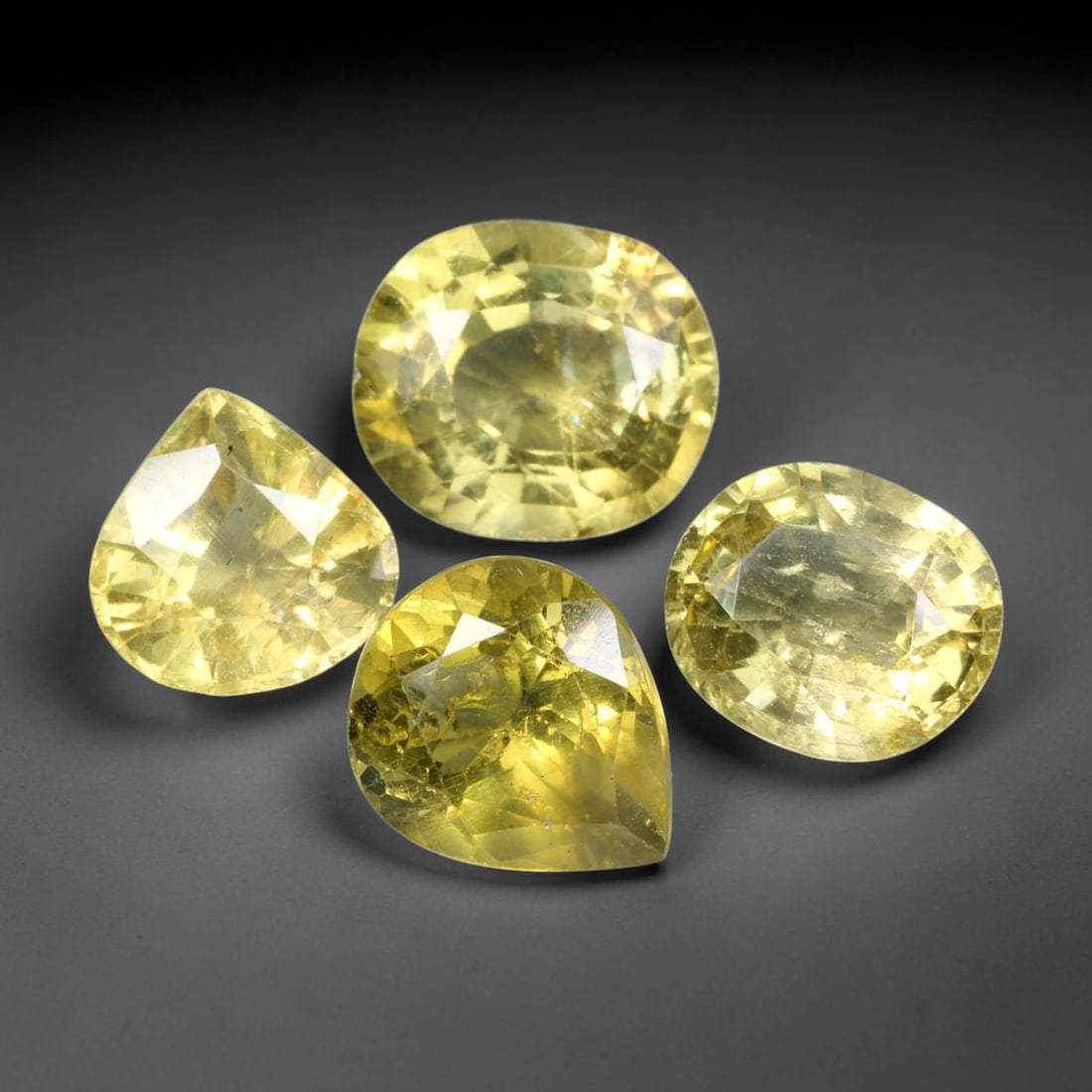 10.01ct Natural Madagascan Lemon Yellow Apatite Loose Gemstone Parcel Lot, 44EV: This bright parcel of apatite exhibits vivid lemon-yellow and golden-yellow hues across mixed oval, pear, cushion and emerald cut forms. Sharp faceting delivers lively sparkle, with warm sunny colour 