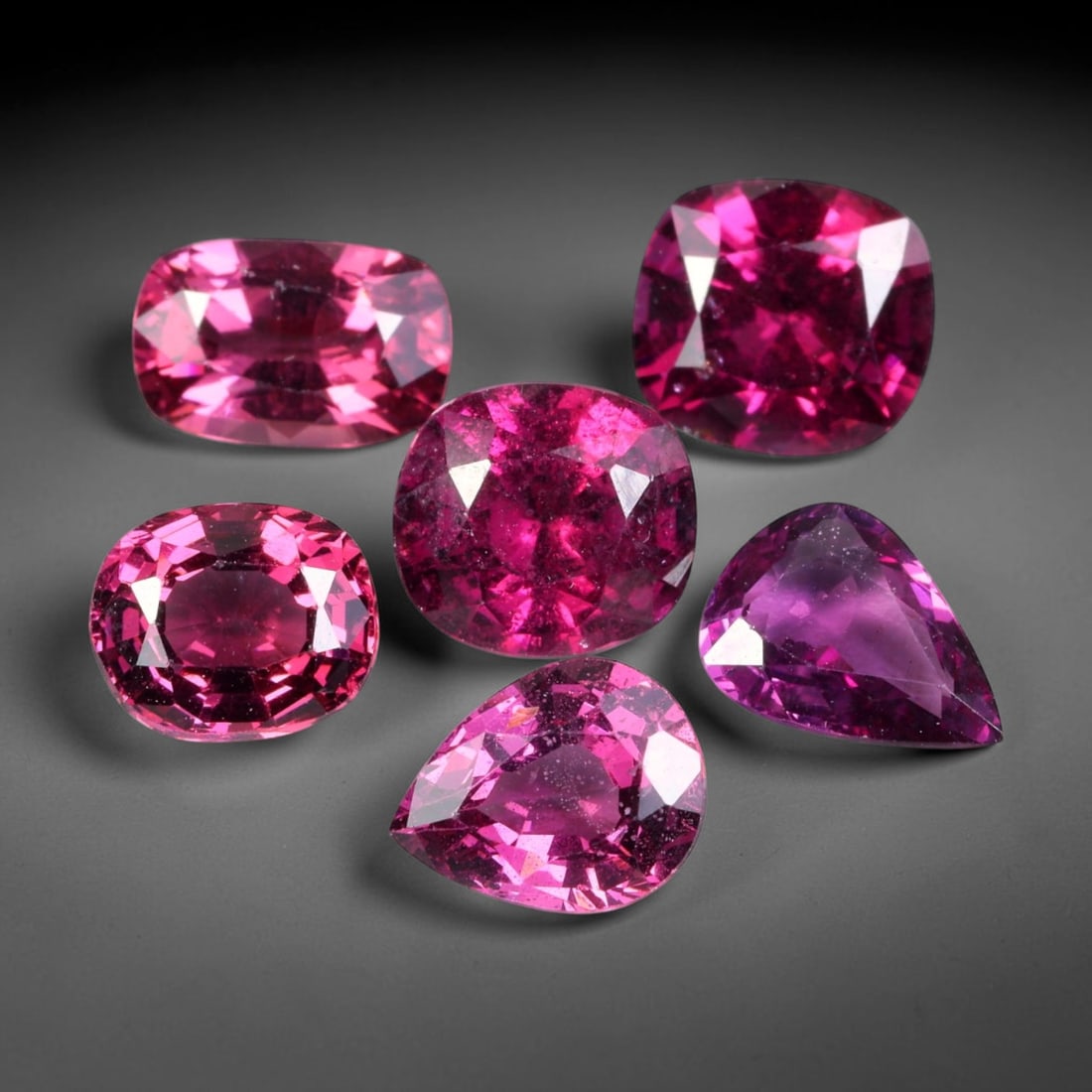 8.71ct Natural Mozambican Raspberry Pink Rhodolite Garnet Loose Gemstone Parcel Lot, 85EV: This dazzling parcel of rhodolite garnet displays rich raspberry-pink and deep magenta tones, brought alive by sharp faceting that delivers vivid sparkle across cushion, oval and pear shapes. Vibrant 