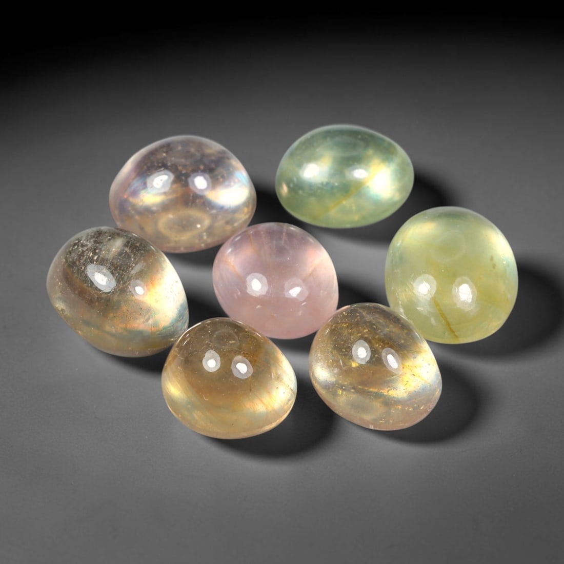 20.23ct Natural Sri Lankan Multi-Tone Sapphire Cabochon Loose Gemstone Parcel Lot, 26EV: This lovely parcel of sapphire cabochons features soft blended tones of pale yellow, champagne and subtle blush pink across smooth polished oval domed surfaces. Gentle iridescent internal reflections 