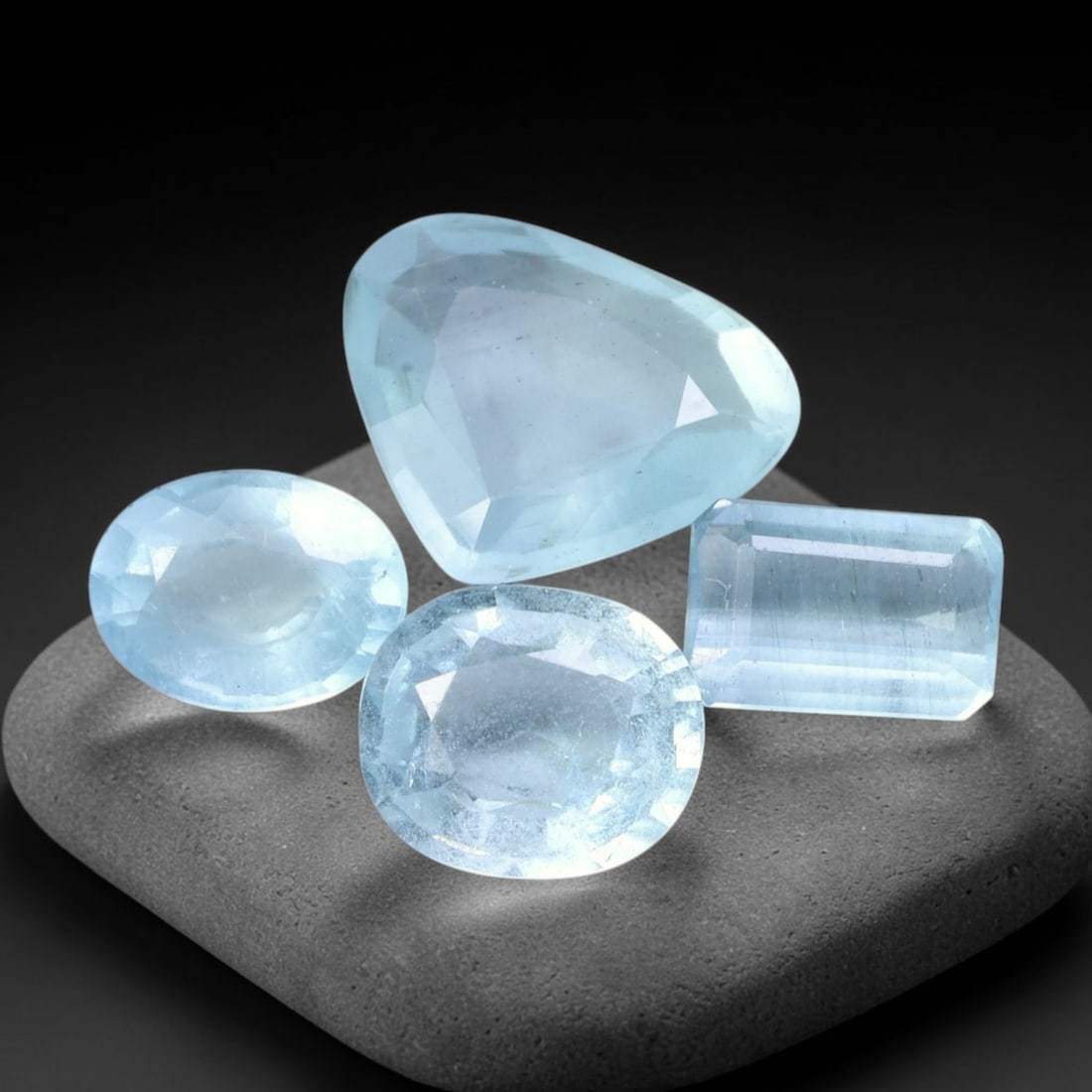 9.61ct Natural Nigerian Sky Blue Aquamarine Loose Gemstone Parcel Lot, 37EV: This lovely parcel of aquamarine exhibits soft sky-blue tones with cool watery translucency, catching light to produce a gentle, airy glow across the faceted surfaces. Mixed faceted shapes bring varie