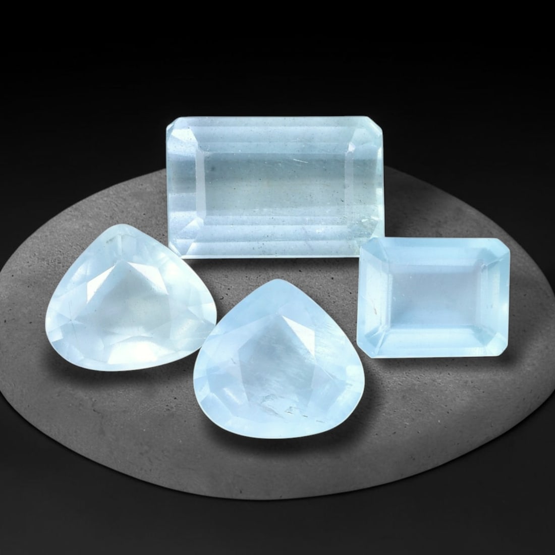 12.27ct Natural Nigerian Sky Blue Aquamarine Loose Gemstone Parcel Lot, 38EV: This lovely parcel of aquamarine exhibits soft sky-blue tones with cool watery translucency, catching light to produce a gentle, airy glow across the faceted surfaces. Mixed faceted shapes bring varie