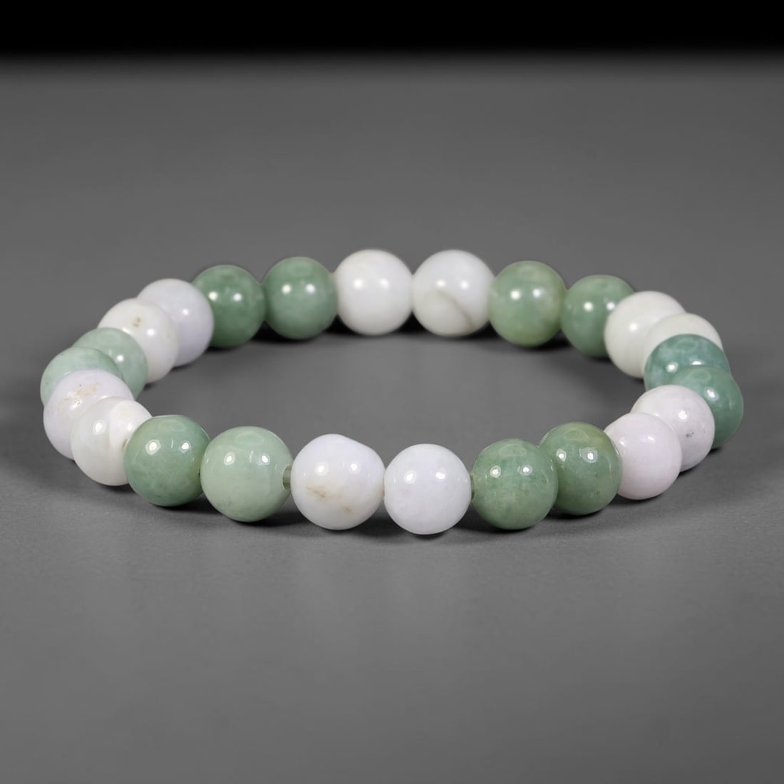 Natural Burmese Type A Jadeite Jade Beaded Bracelet, 8FJ: Constructed from polished natural jadeite jade round beads with blended soft natural tones. Each bead measures 8mm, strung as a flexible stretch bracelet. Simple, elegant design perfect for everyday w