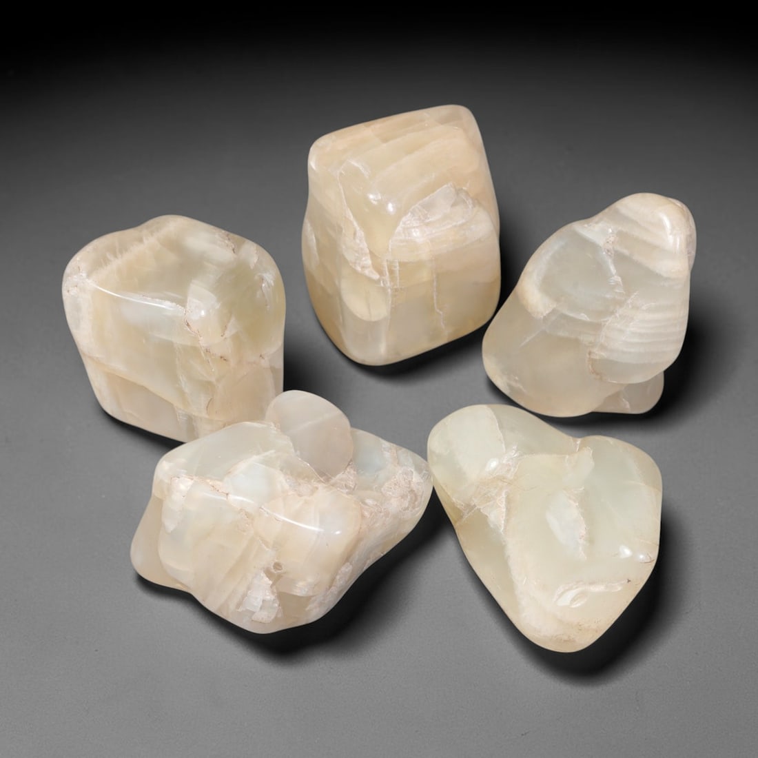 315ct Natural Ceylon Moonstone Tumbled Rough Parcel Lot, 5EW: This parcel features naturally tumbled Ceylon moonstone rough displaying soft creamy pale-hued translucent bodies with natural internal fractures and textural layering. Smooth water-worn surfaces show