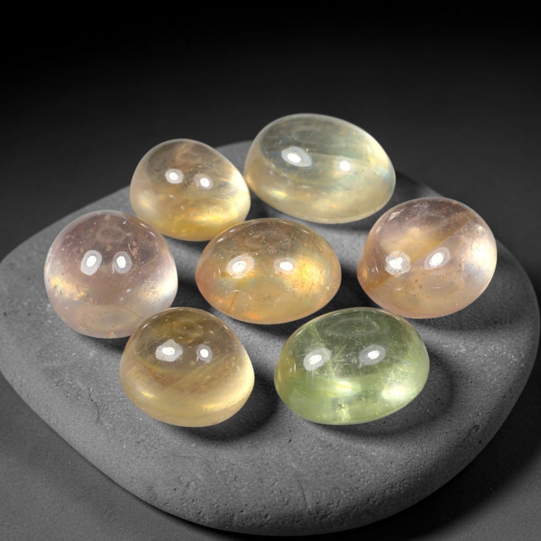 17.24ct Natural Sri Lankan Multi-Tone Sapphire Cabochon Loose Gemstone Parcel Lot, 27EV: This lovely parcel of sapphire cabochons features soft blended tones of pale yellow, champagne and subtle blush pink across smooth polished oval domed surfaces. Gentle iridescent internal reflections 