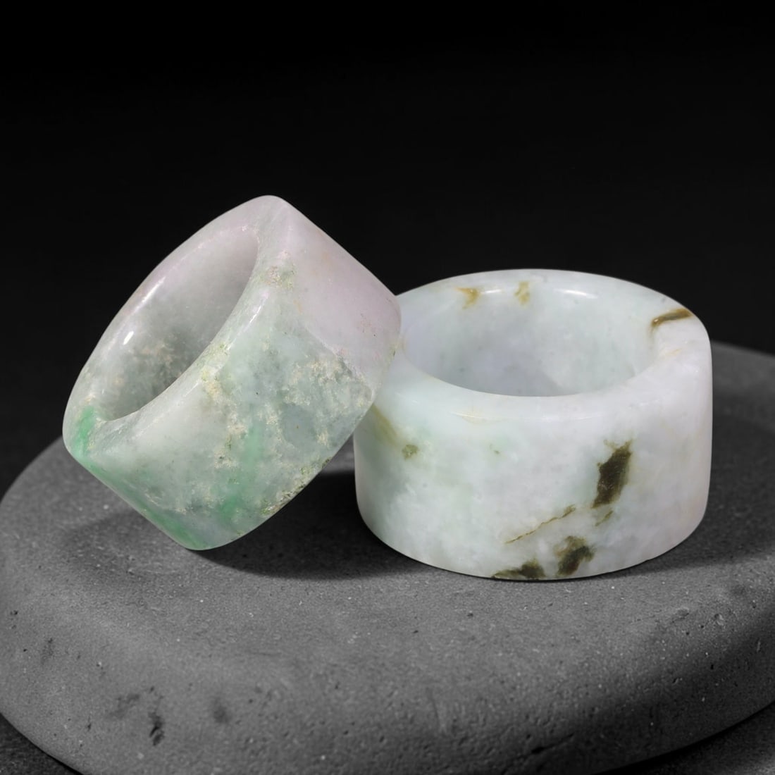 Burmese Type-A Jadeite Jade Thumb Rings Chinese Archer Set, 28EW: Crafted from natural Burmese Type-A jadeite jade, this matching pair of archer's thumb rings displays mottled green, pale lavender and dark mineral inclusions within the stone. Each ring is formed as 