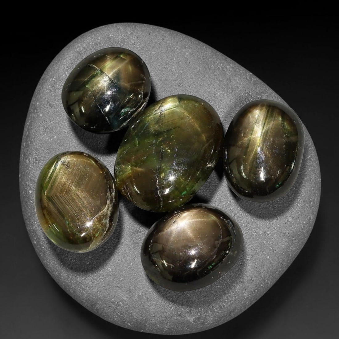 12.60ct Natural Siamese Golden Star Sapphire Cabochon Loose Gemstone Parcel Lot, 73EV: This striking parcel of Siamese golden star sapphire cabochons features deep smoky-golden body tones with sharp well-defined six-rayed asterism across smooth polished oval domed surfaces. Bright metal