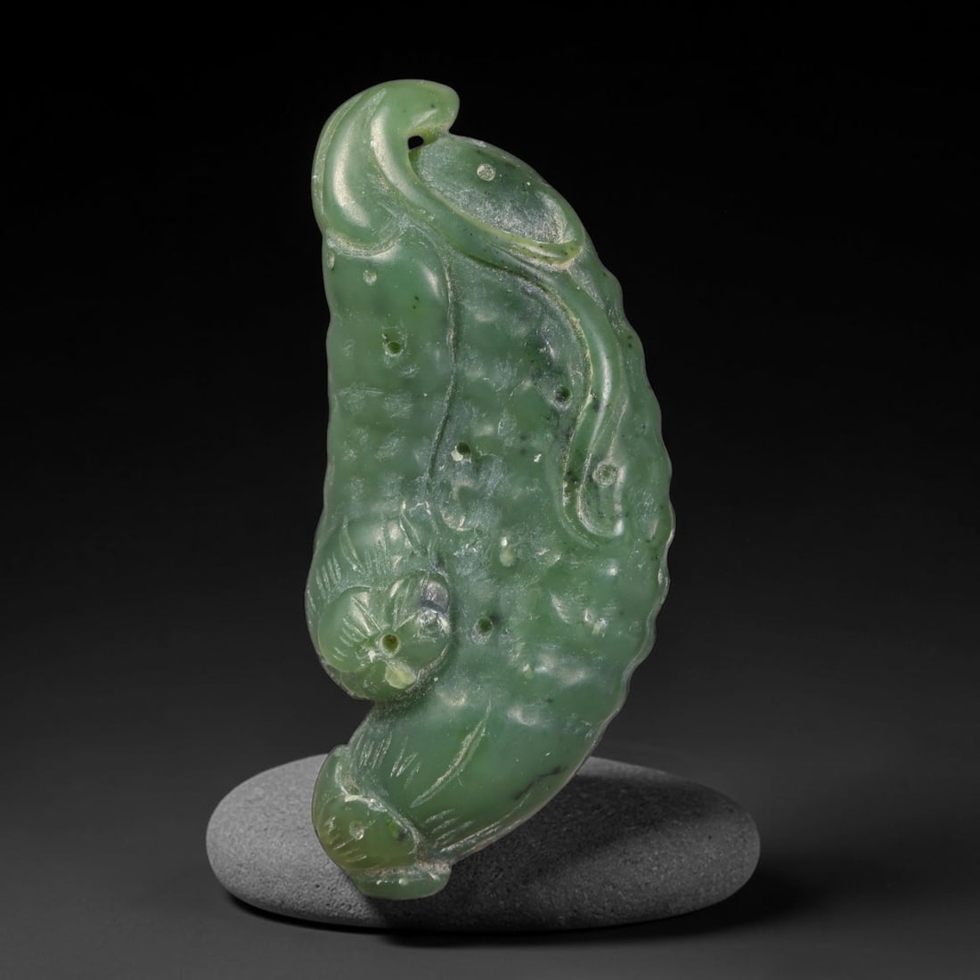 Natural Chinese Hetian Nephrite Jade Carved Pendant, 86AT: This ornamental carving is crafted from natural Chinese Hetian nephrite jade, displaying rich deep spinach-green body colour scattered with characteristic dark mineral speckles throughout the stone. T