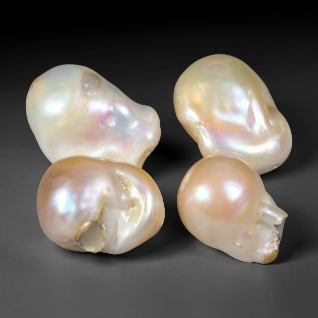 127ct Natural Freshwater Baroque Pearl Loose Gemstone Parcel Lot, 48EV: This eye-catching parcel of freshwater baroque pearls exhibits organic free-form silhouettes, glowing with soft iridescent luster across each uneven surface. Gentle shifts of creamy white, blush peach