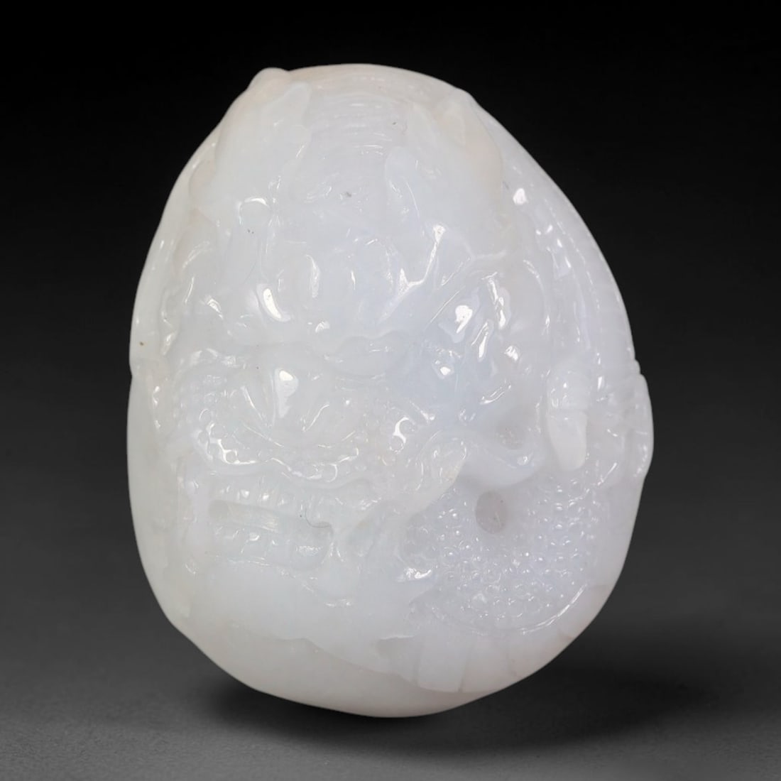 Natural Burmese Type A Jadeite Jade Dragon Carved Pendant, 23BP: This solid carved pendant is crafted from natural Burmese Type A jadeite jade, exhibiting soft milky-white translucent body tone with fine smooth polish across the entire surface. The piece features d