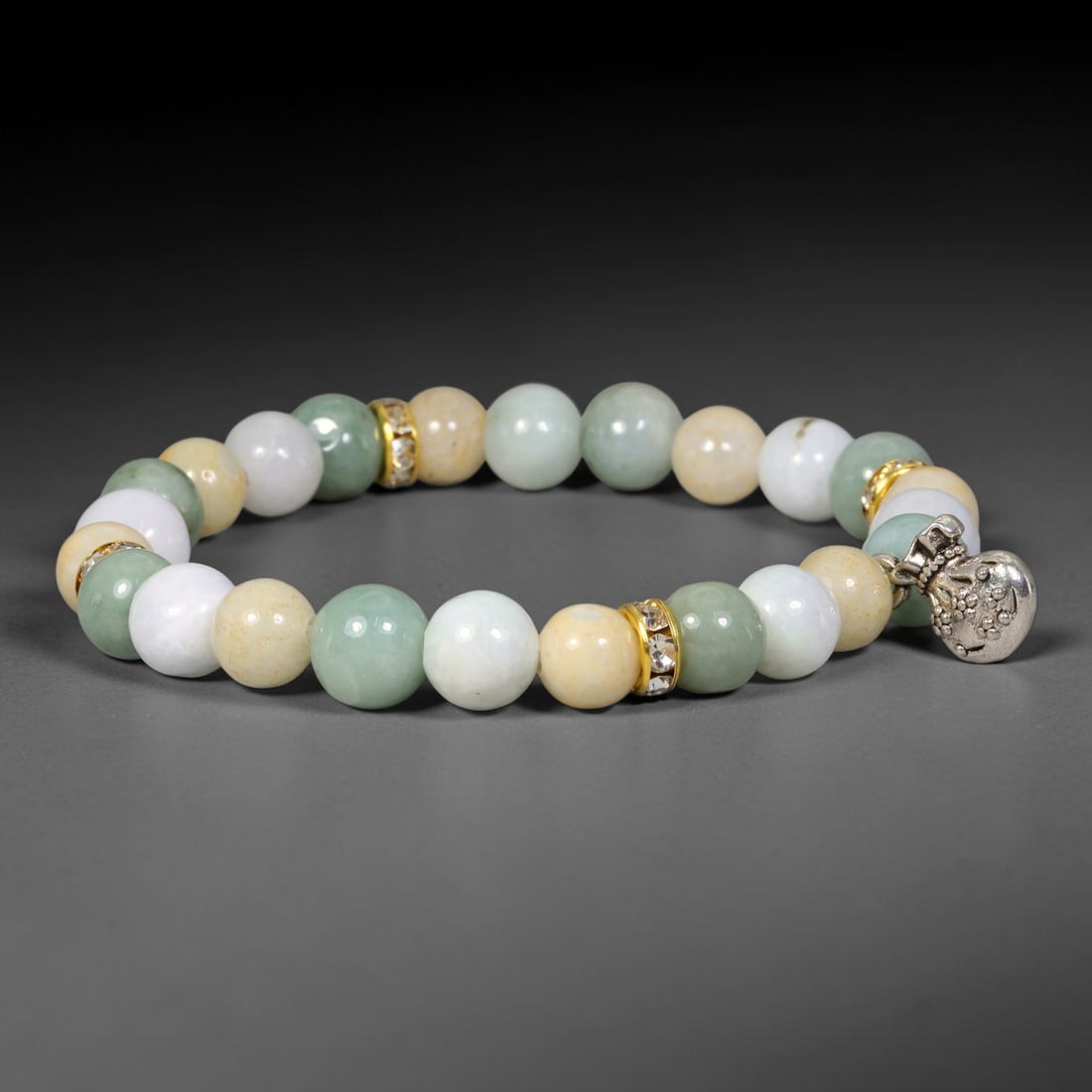 Natural Burmese Type A Jadeite Jade Beaded Bracelet, 25EP: Polished natural jadeite jade round beads complemented by decorative crystal spacer accents. Uniform 9mm beads form a flexible wearable strand. A timeless gemstone bracelet suitable for daily styling,