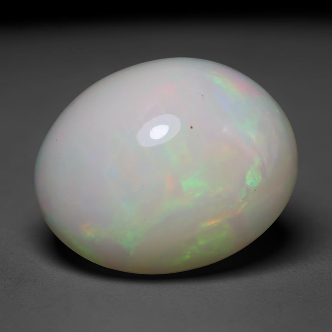 6.14ct Natural Ethiopian Welo Opal Cabochon Loose Gemstone, 25BY: This smoothly polished cabochon is genuine natural Ethiopian Welo opal. The translucent base hosts vivid multi-coloured play-of-colour, displaying dynamic flashes of multi color that shift as the view