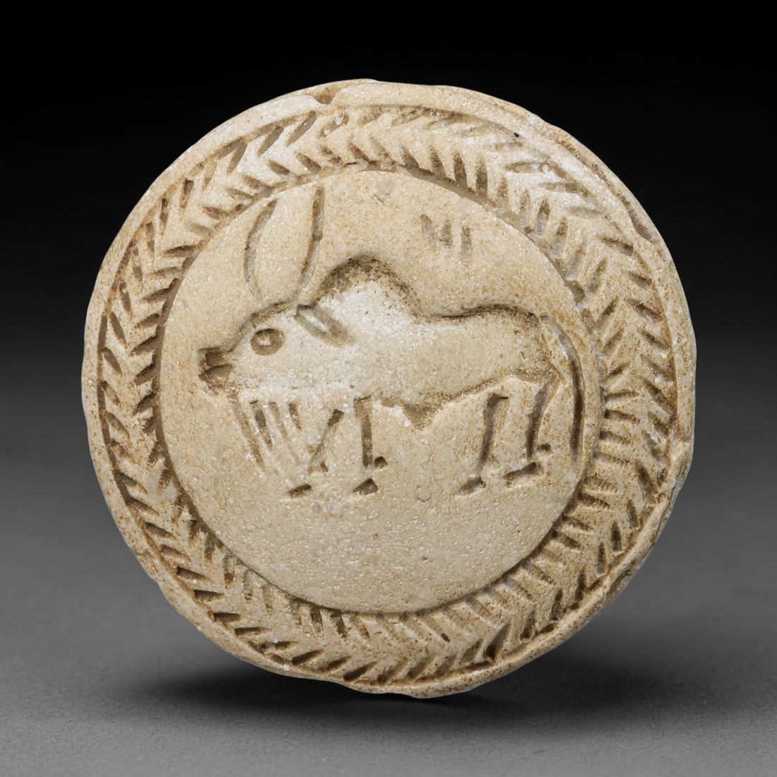 Ancient Sasanian Persian Double Convex Zoomorphic Intaglio Bead (224-651 CE), 23EF: This ancient double convex intaglio bead is carved from pale limestone, originating from the Sasanian Persian Empire, celebrated for crafting stone seal amulets bearing zoomorphic imagery tied to Zoro