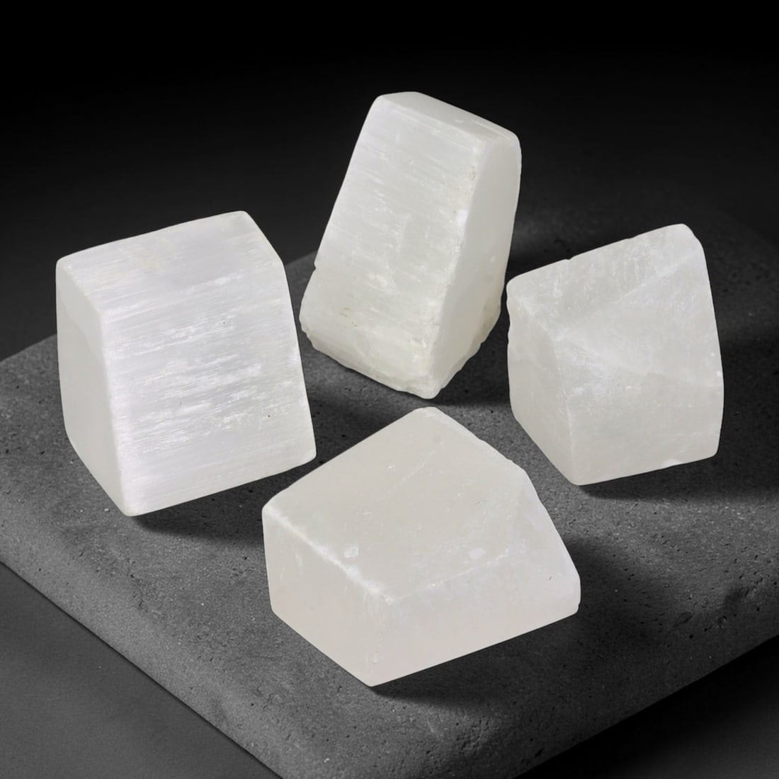 291ct Natural Moroccan Selenite Rough Parcel Lot, 25EW: This parcel of natural selenite rough consists of translucent milky-white crystalline specimens displaying distinct parallel striations and tabular cleavage planes characteristic of gypsum mineral str