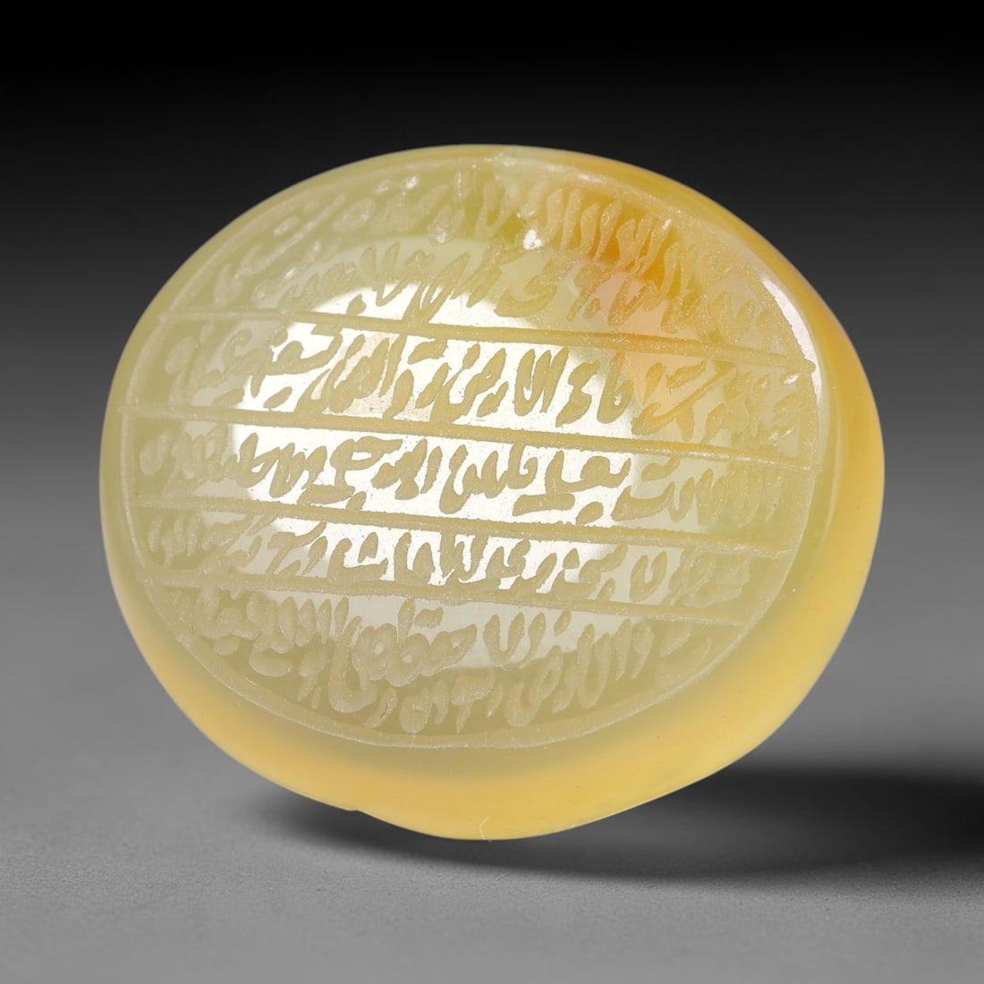 Ancient Medieval Mughal Islamic Carnelian Agate Calligraphic Script Talisman 1526-1857 CE, 34ET: Polished rich-toned carnelian agate cabochon, finely engraved with divided panels of Islamic calligraphic intaglio inscriptions. Deep crisp engraving features segmenting incised lines organizing the s