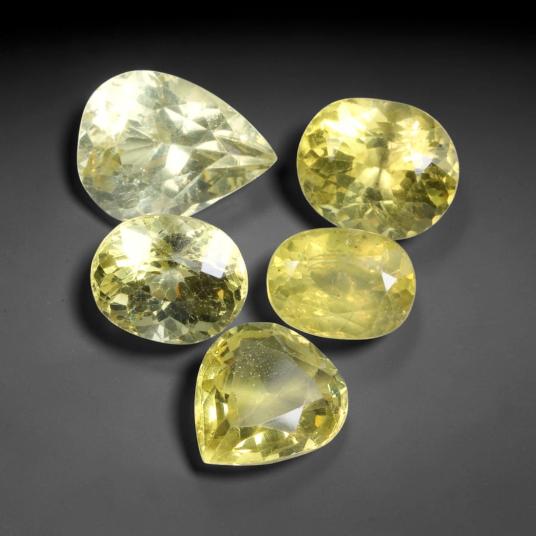 10.88ct Natural Madagascan Lemon Yellow Apatite Loose Gemstone Parcel Lot, 43EV: This bright parcel of apatite exhibits vivid lemon-yellow and golden-yellow hues across mixed oval, pear, cushion and emerald cut forms. Sharp faceting delivers lively sparkle, with warm sunny colour 