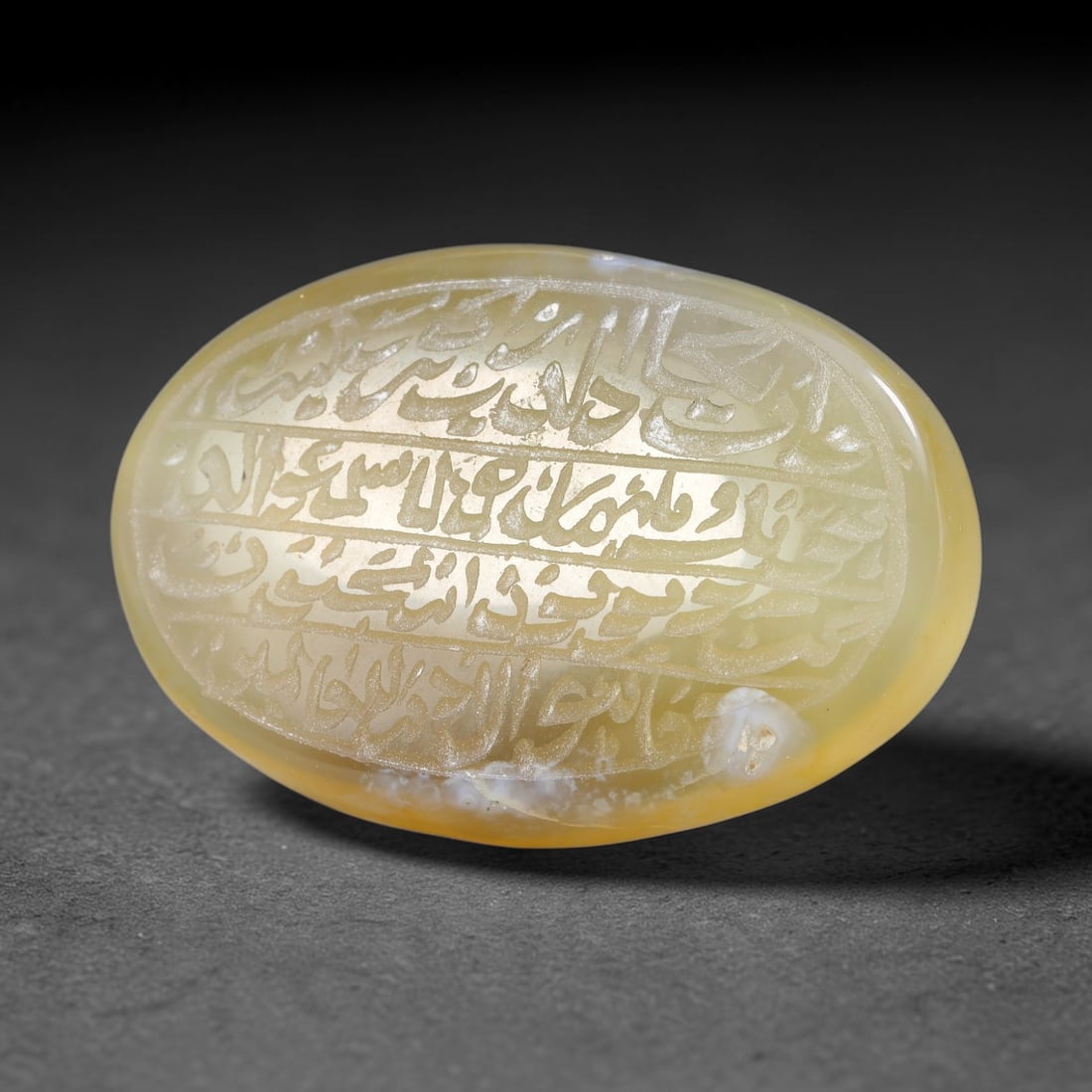 Ancient Medieval Mughal Islamic Carnelian Agate Calligraphic Script Talisman 1526-1857 CE, 8ET: Polished rich-toned carnelian agate cabochon, finely engraved with divided panels of Islamic calligraphic intaglio inscriptions. Deep crisp engraving features segmenting incised lines organizing the s
