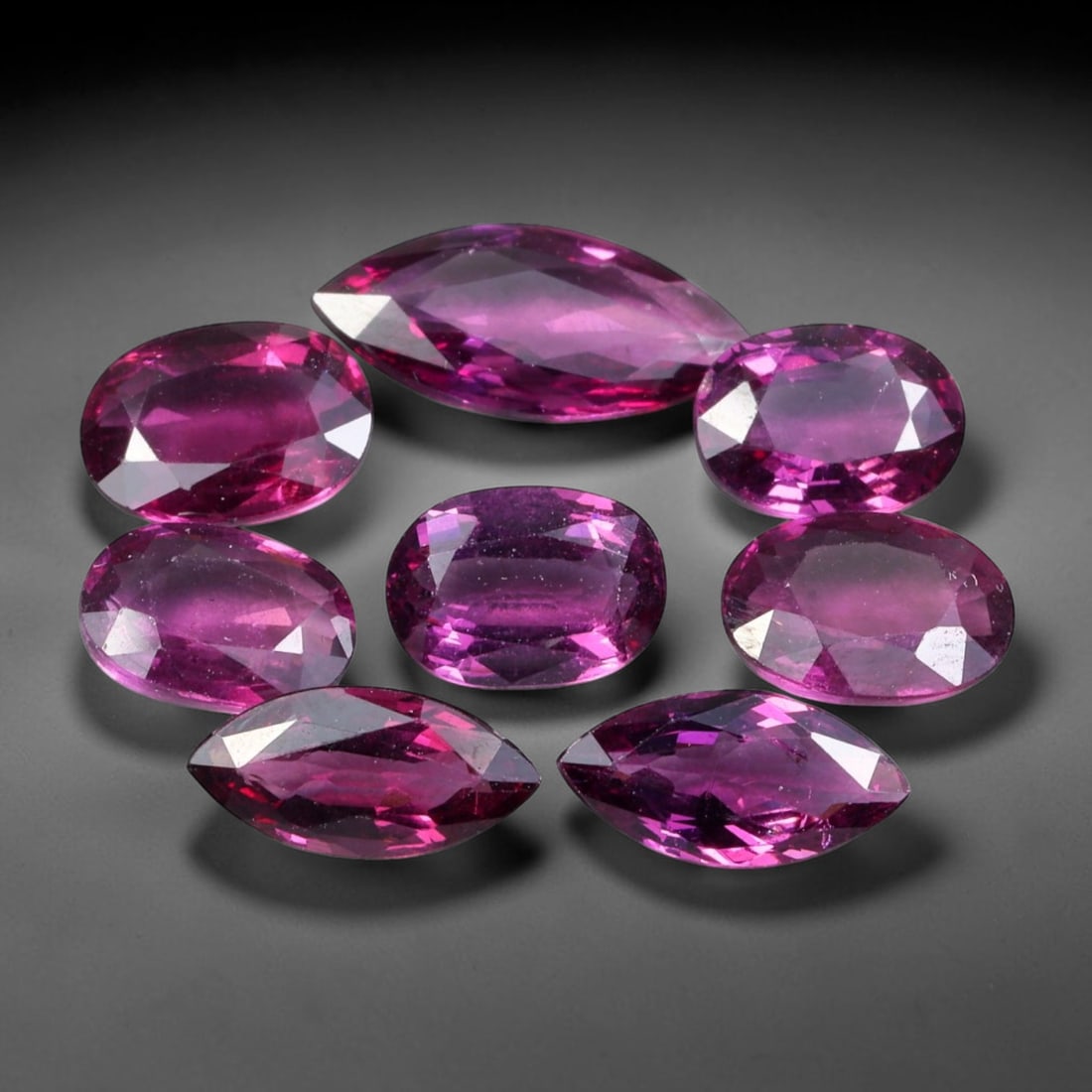 9.22ct Natural Mozambican Rhodolite Garnet Loose Gemstone Parcel Lot, 59EV: This vibrant parcel of rhodolite garnet displays rich saturated magenta-rose tones across a varied assortment of oval, marquise and pear faceted cuts. Precise faceting produces bright sparkle, highlig