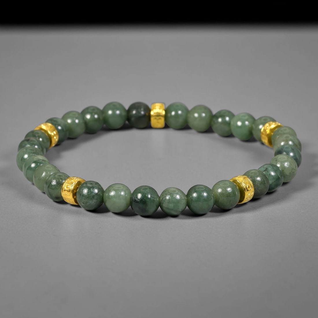 Natural Burmese Type A Jadeite Jade Beaded Bracelet, 24FJ: Features polished natural jadeite jade round beads paired with decorative gold tone spacer accents. Uniform 6mm beads form a flexible strand bracelet. This refined gemstone bracelet suits everyday wea