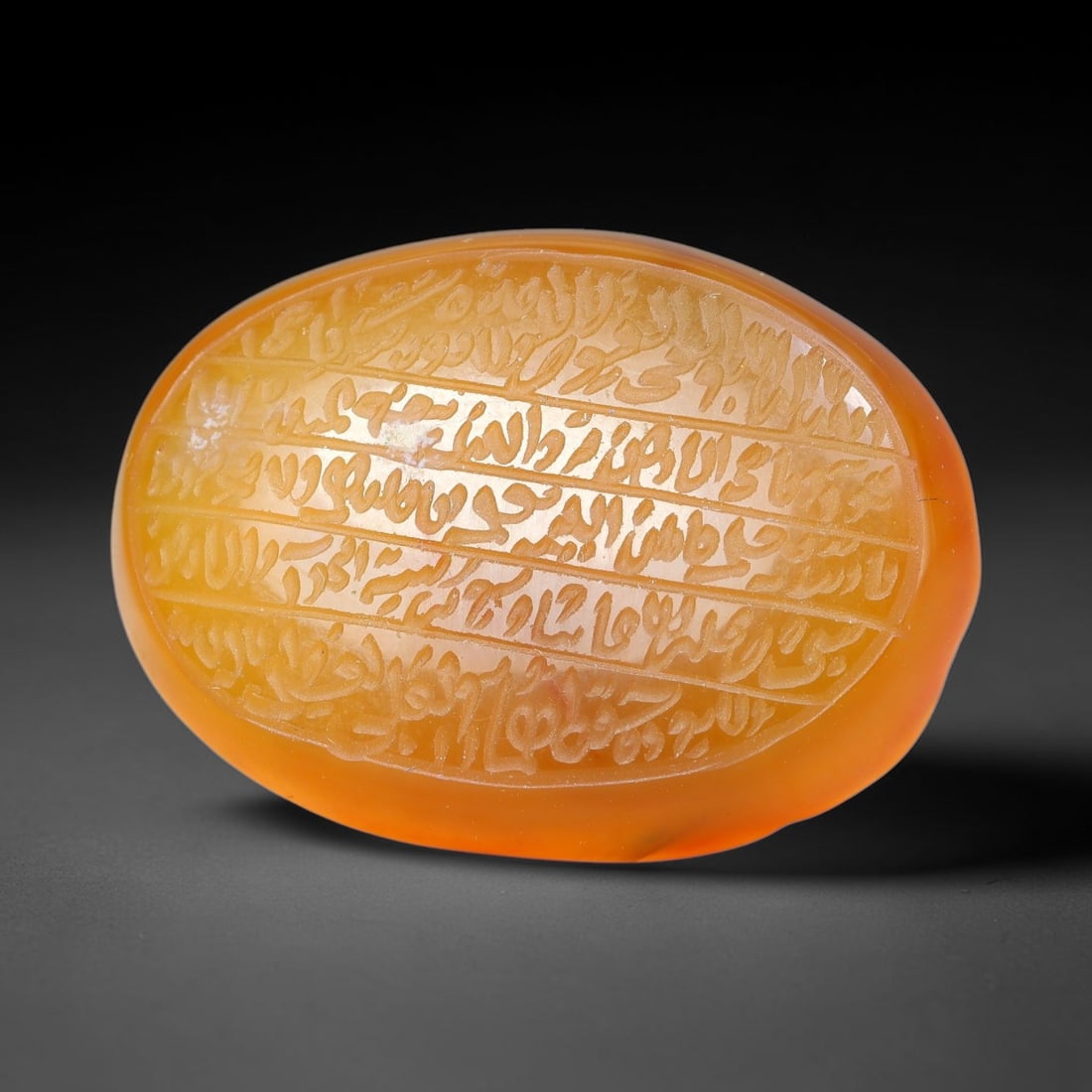 Ancient Medieval Mughal Islamic Carnelian Agate Calligraphic Script Talisman 1526-1857 CE, 89ES: Polished rich-toned carnelian agate cabochon, finely engraved with divided panels of Islamic calligraphic intaglio inscriptions. Deep crisp engraving features segmenting incised lines organizing the s
