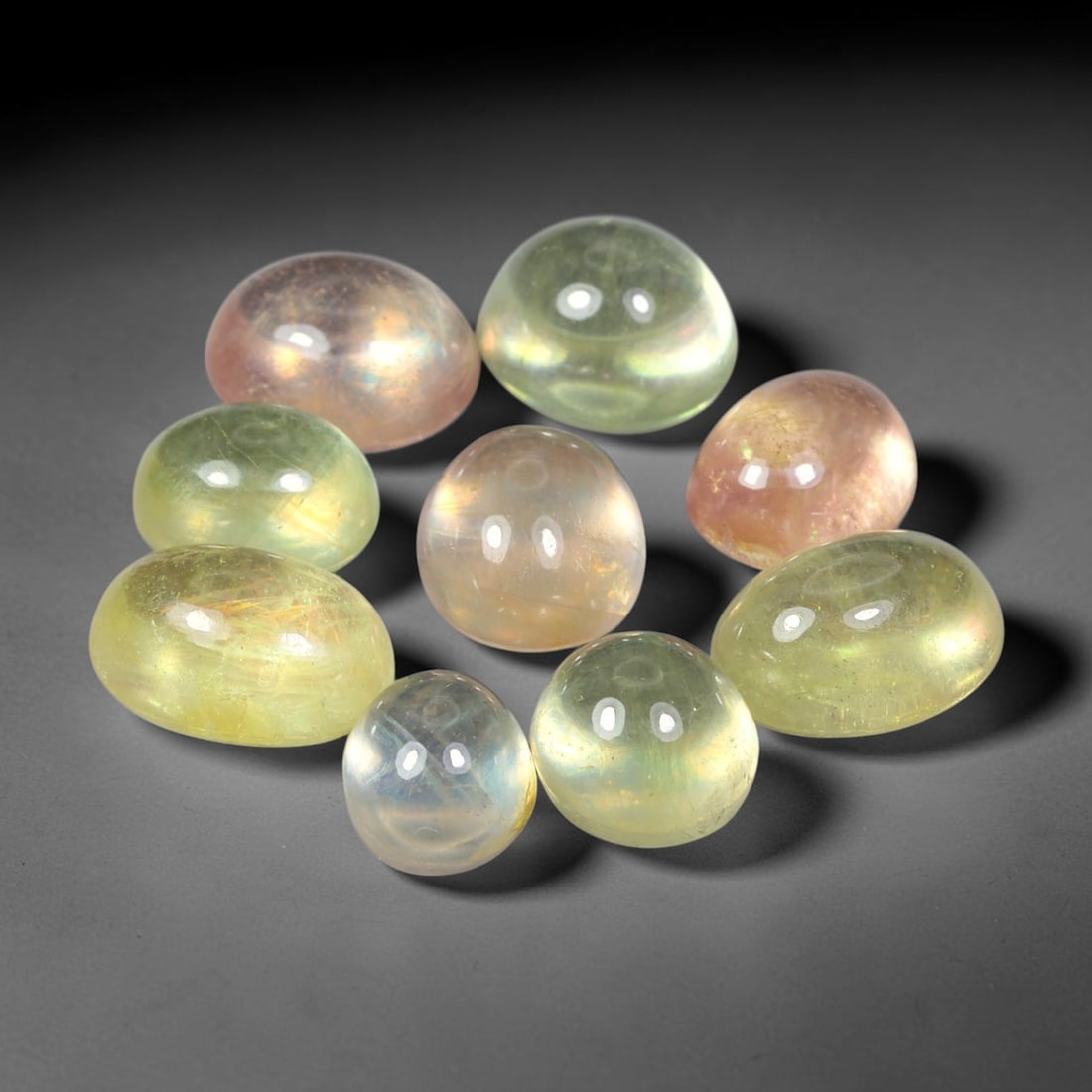 26.17ct Natural Sri Lankan Multi-Tone Sapphire Cabochon Loose Gemstone Parcel Lot, 28EV: This lovely parcel of sapphire cabochons features soft blended tones of pale yellow, champagne and subtle blush pink across smooth polished oval domed surfaces. Gentle iridescent internal reflections 