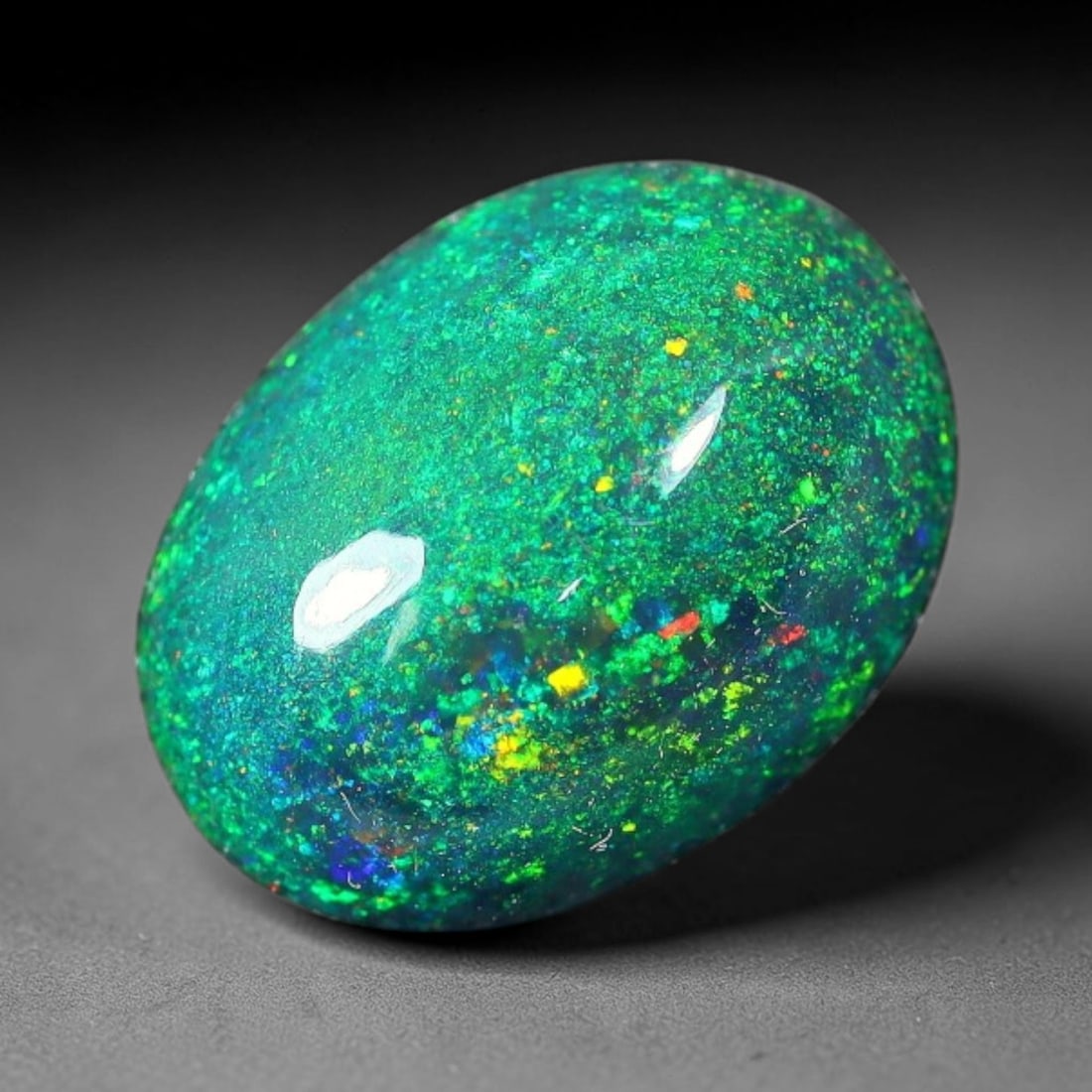 1.67ct Natural Ethiopian Welo Black Smoked Opal Cabochon Loose Gemstone, 64FX: This fully polished Ethiopian Welo opal features a dark smoked base with vivid, sweeping play-of-color shifting across its glossy dome surface, measured at 10x8x4mm. The black smoke treatment deepens 