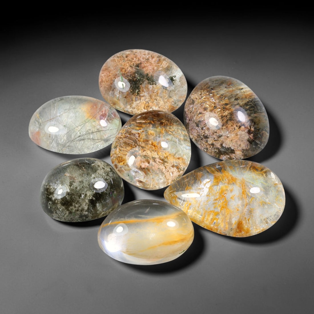 224.08ct Natural Brazilian Phantom Quartz Cabochon Parcel Lot, 70EW: This polished cabochon parcel of natural phantom quartz features transparent clear quartz host stone enclosing intricate internal phantom mineral deposits. Each oval cabochon displays unique scenic in