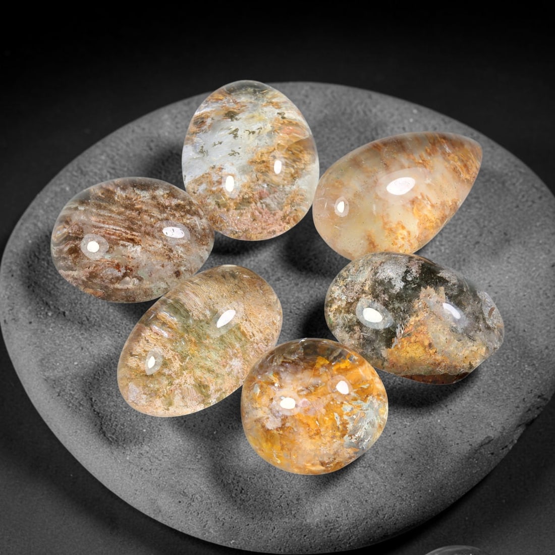 179.39ct Natural Brazilian Phantom Quartz Cabochon Parcel Lot, 61EW: This polished cabochon parcel of natural phantom quartz features transparent clear quartz host stone enclosing intricate internal phantom mineral deposits. Each oval cabochon displays unique scenic in
