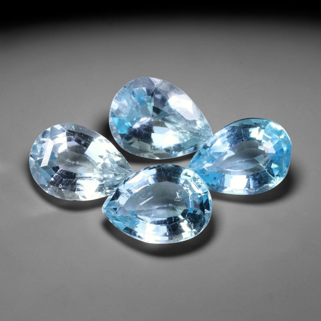 13.96ct Natural Brazilian Blue Topaz Faceted Parcel Lot, 47EW: This faceted parcel consists of pear-shaped blue topaz gems exhibiting cool, translucent sky-to-medium blue colour tones. Each stone features precise pear form faceting with crisp polished facets, del