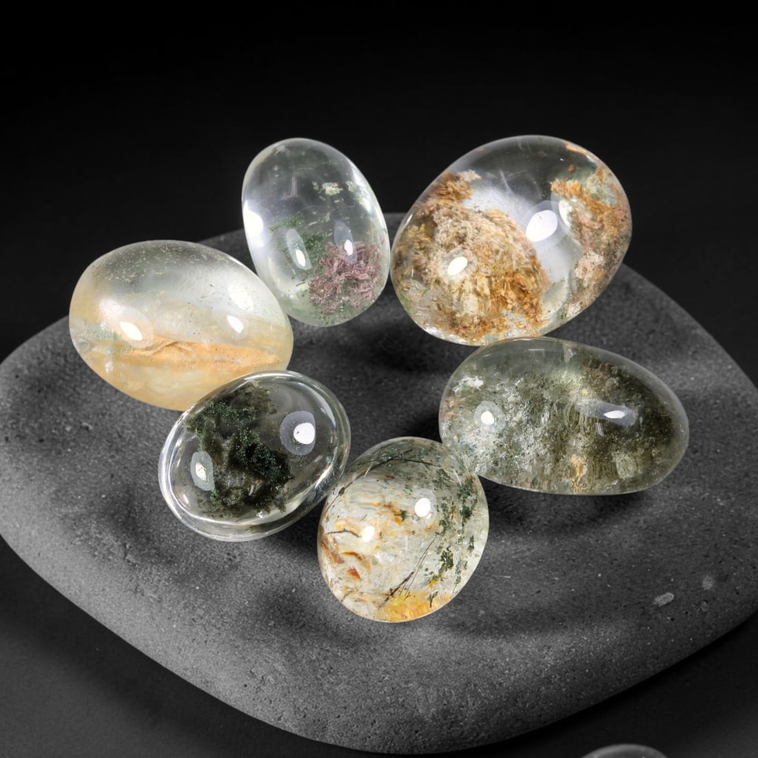 190.50ct Natural Brazilian Phantom Quartz Cabochon Parcel Lot, 62EW: This polished cabochon parcel of natural phantom quartz features transparent clear quartz host stone enclosing intricate internal phantom mineral deposits. Each oval cabochon displays unique scenic in