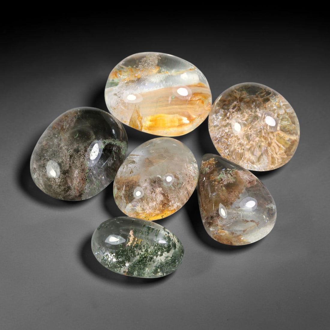 190ct Natural Brazilian Phantom Quartz Cabochon Parcel Lot, 58EW: This polished cabochon parcel of natural phantom quartz features transparent clear quartz host stone enclosing intricate internal phantom mineral deposits. Each oval cabochon displays unique scenic in