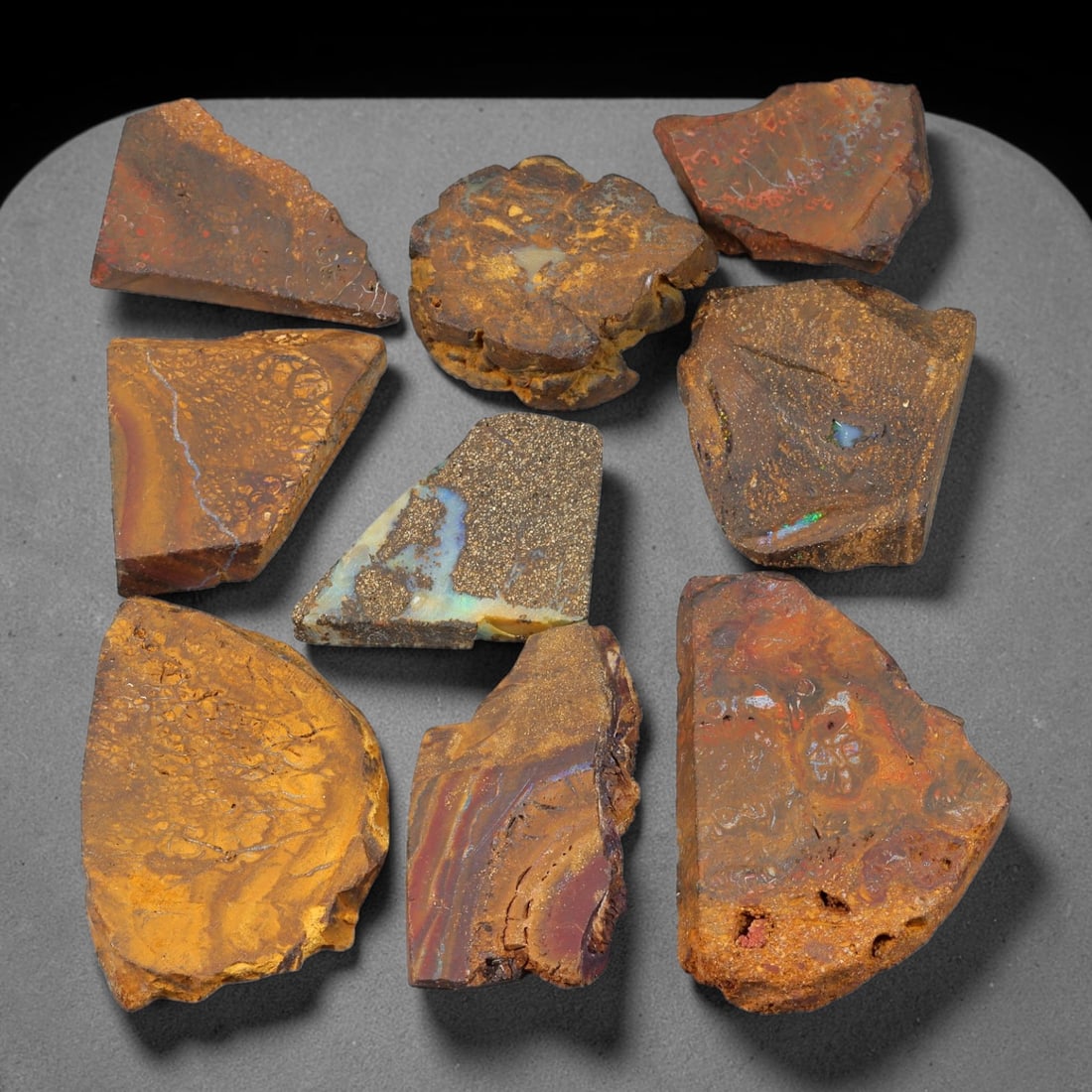 385ct Natural Australian Queensland Boulder Opal Sliced Rough Parcel Lot, 65EX: This sliced rough parcel features multiple boulder opal slices displaying striking natural opal colour flashes set within solid ironstone host matrix. The slices exhibit varied patterns including vivi