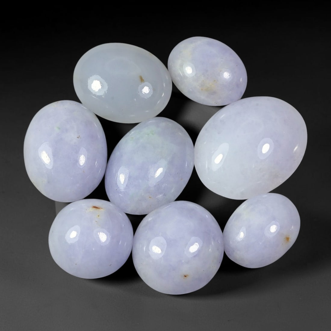 72.31ct Natural Burmese Type A Lavender Jadeite Jade Cabochon Parcel Lot, 38EX: This polished cabochon parcel features oval and round cabochon Type A jadeite jade displaying soft lavender-lilac body tones across the set. Smooth high-gloss domed surfaces showcase gentle colour var