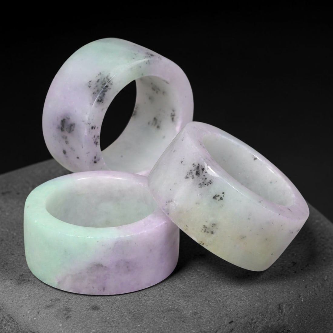 Burmese Type-A Jadeite Jade Thumb Rings Chinese Archer Set, 53EX: Crafted from natural Burmese Type-A jadeite jade, these archer's thumb rings displays mottled green, pale lavender and dark mineral inclusions within the stone. Each ring is formed as a thick cylindri