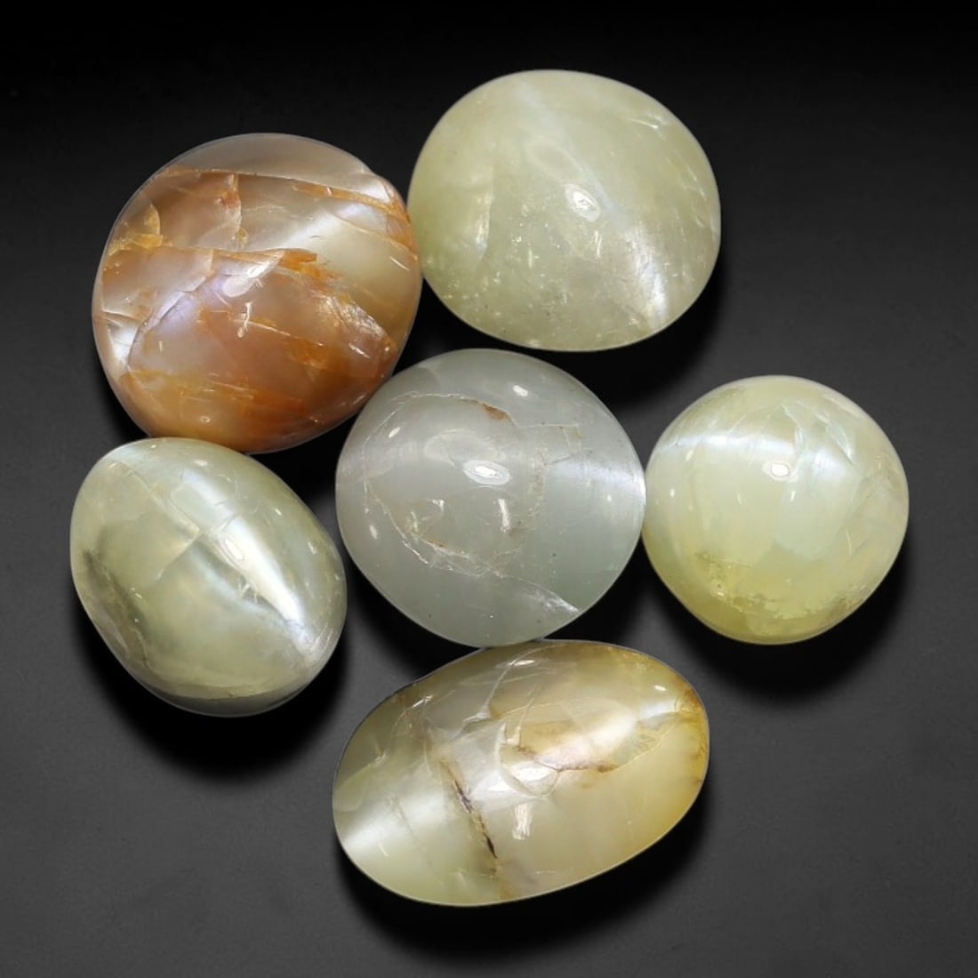 10.63ct Natural Ceylon Chrysoberyl Cat's Eye Cabochon Parcel Lot, 22EX: This polished cabochon parcel features oval and round cabochon chrysoberyl cat's eye from Sri Lanka. Smooth domed surfaces display sharp, well-defined chatoyant cat's-eye band across soft yellowish-gr