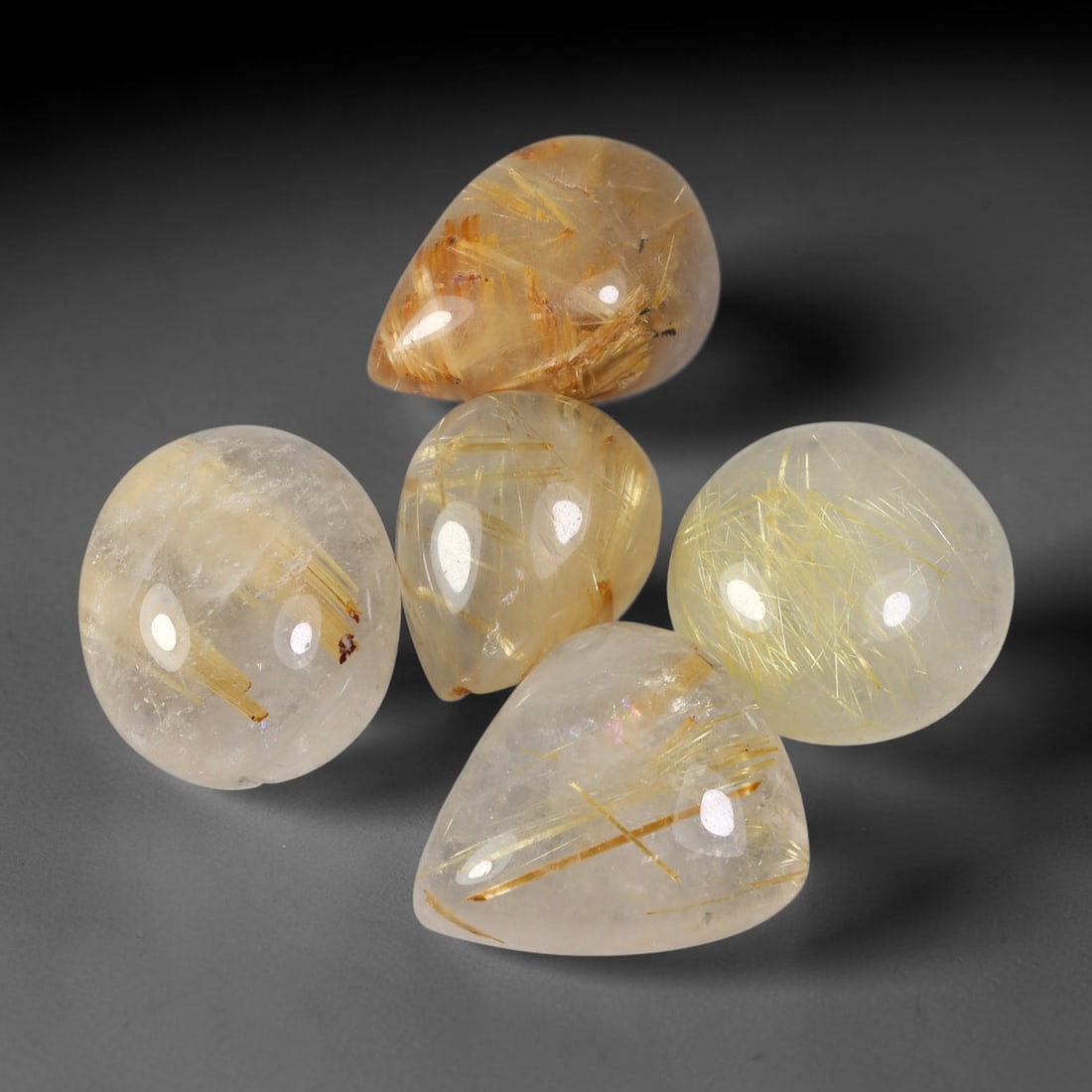 56ct Natural Brazilian Rutile Quartz Cabochon Parcel Lot, 29EX: This polished cabochon parcel features finished rutilated quartz cabochons with clear translucent quartz host saturated with fine golden-yellow rutile needle inclusions. Smooth high-gloss domed surfac
